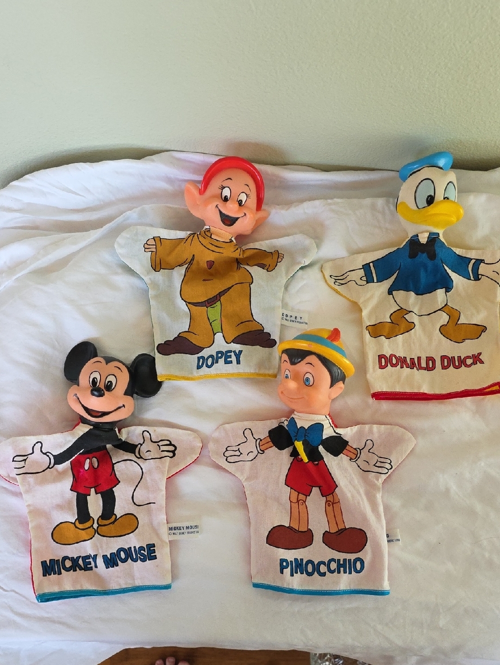 Vintage Walt Disney hand puppets featuring Mickey, Dopey, Donald and Pinocchio